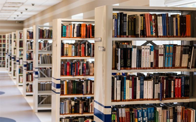 A library of shelves receding into depth, suggesting a body of knowledge to retrieve answers from